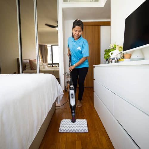 Sureclean Employee Cleaning the Bedroom Floor