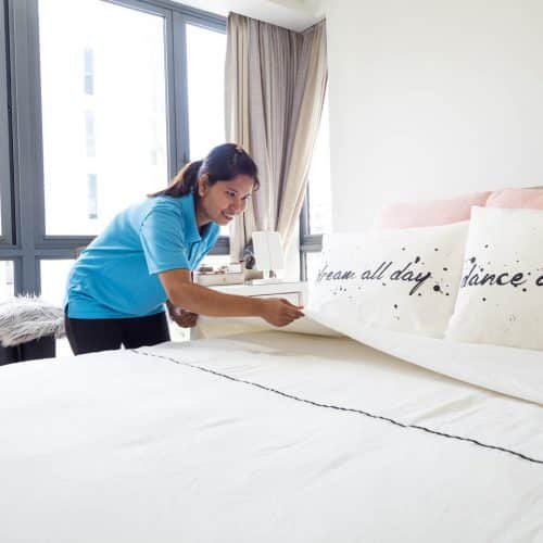 Sureclean's employee cleaning the bed